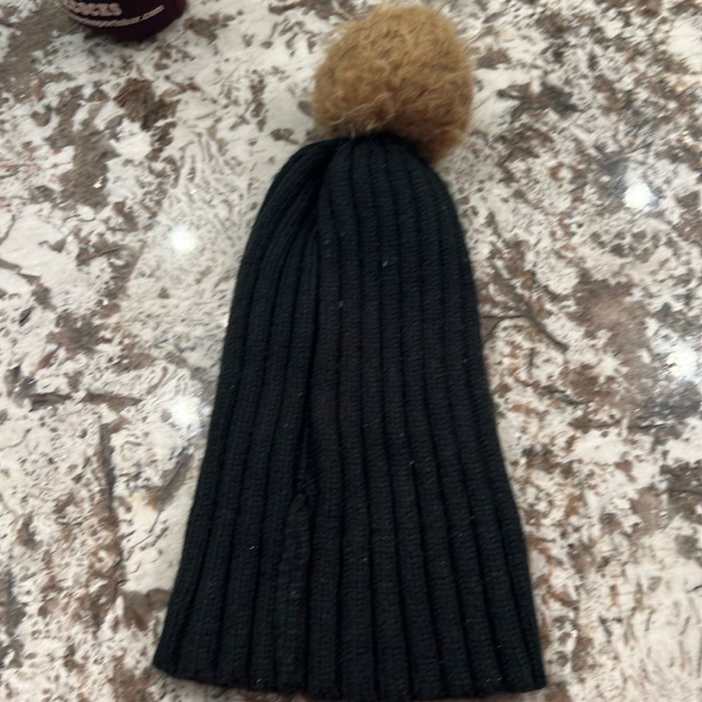 Black and brown 100% Acrylic and one size fits all brown ball on top precious